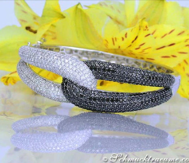 Schwarz-weiß Diamant-Armreif aus Weißgold, Detailaufnahme mit gelber Blume im Hintergrund. Schwarz-weiß Diamant-Armreif aus Weißgold, Detailaufnahme mit gelber Blume im Hintergrund.