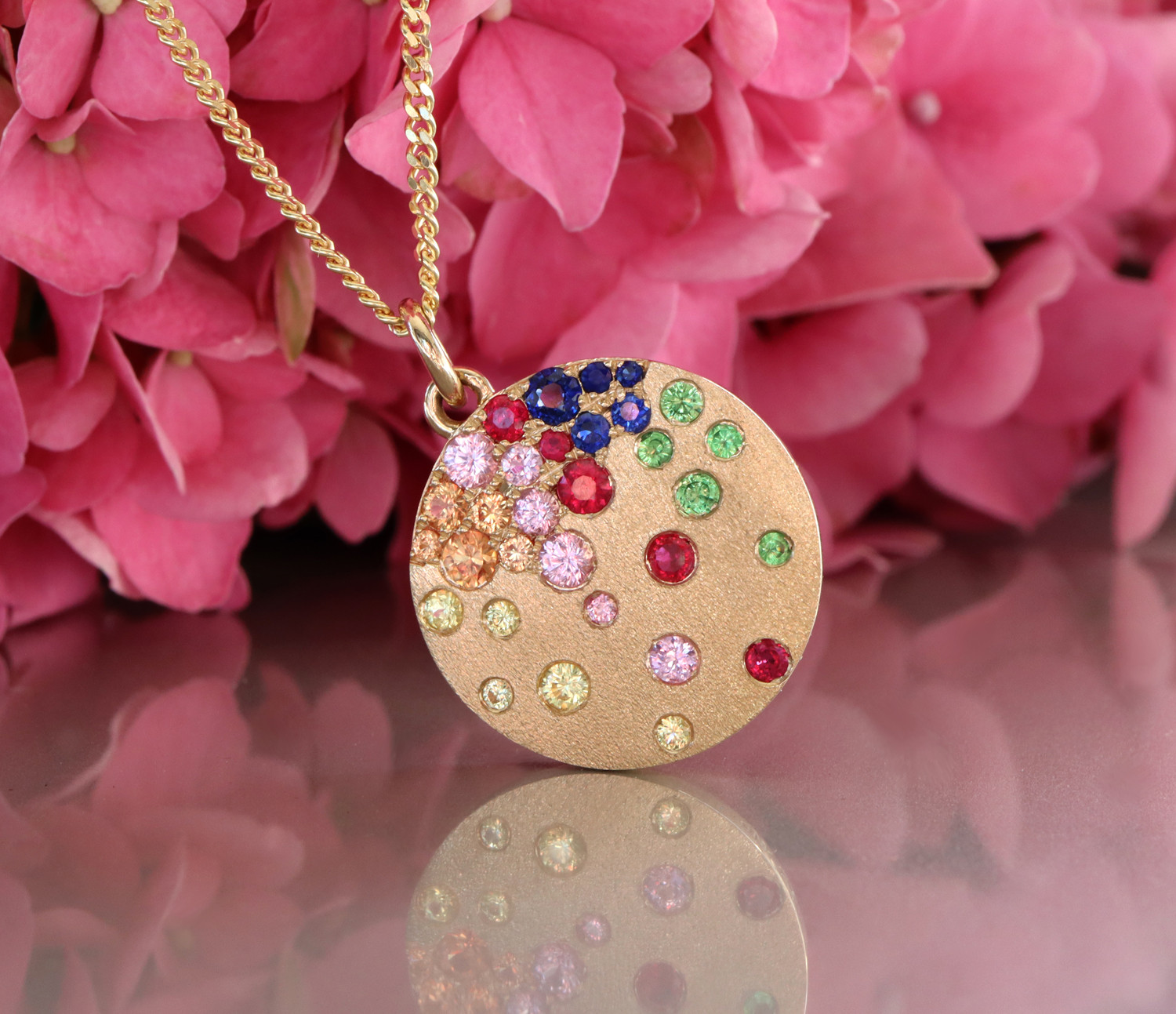 Goldene Medaillon-Halskette mit farbenfrohen Saphiren, Rubinen und Tsavorites.