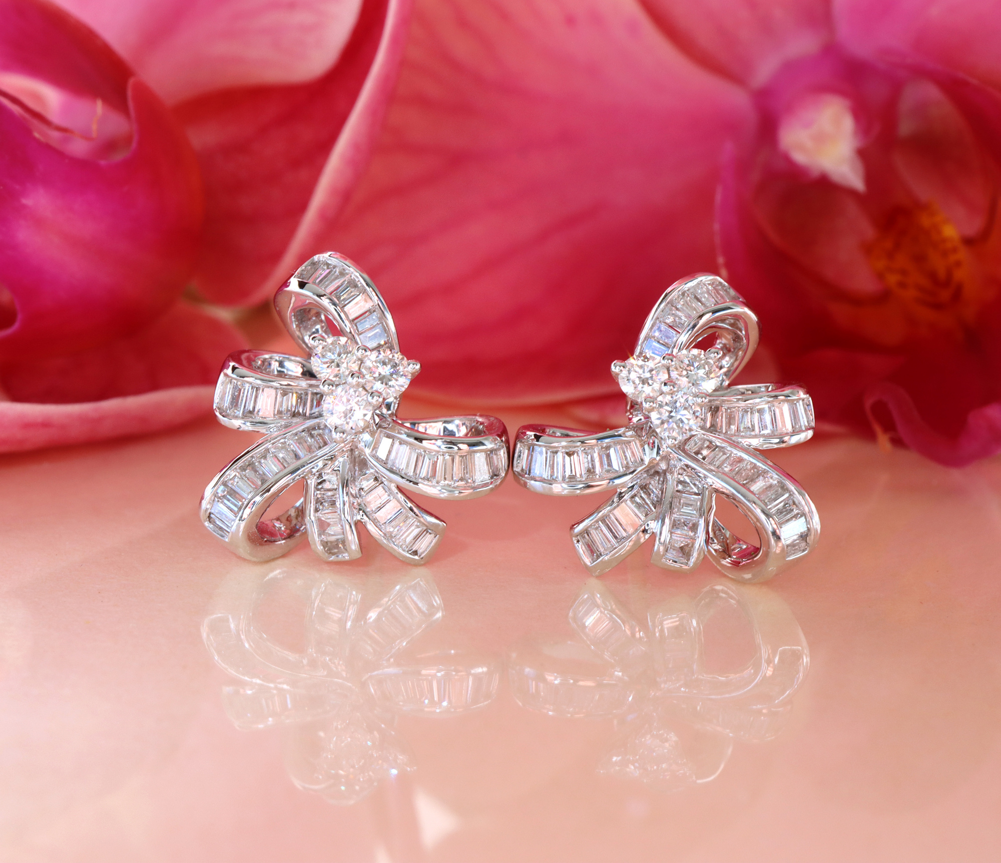 Diamantenschleifen-Ohrringe im Baguette-Stil auf rosa Hintergrund