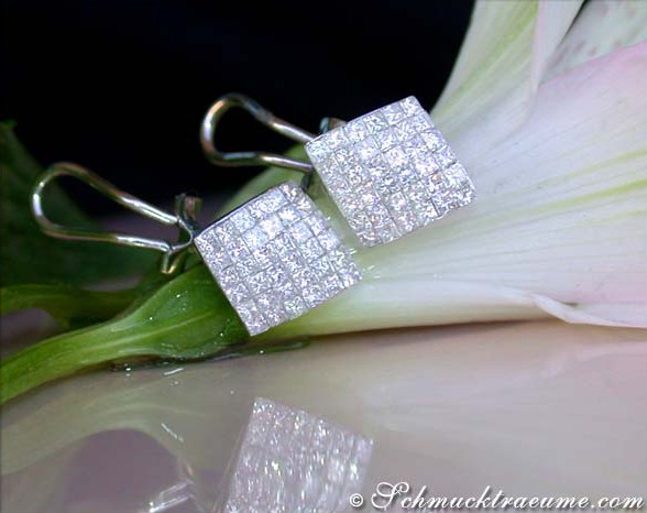 Prinzessinen-Diamant-Ohrstecker mit Invisible Setting auf Blume liegend