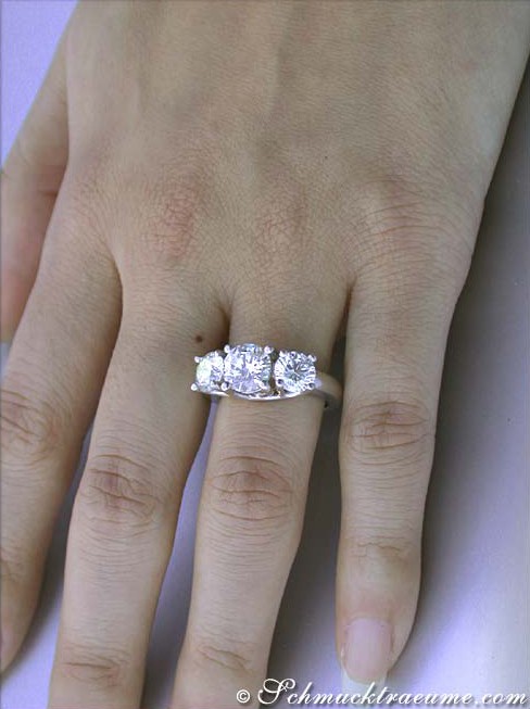 Klassischer Diamantring mit drei Solitären, Detailaufnahme auf der Hand