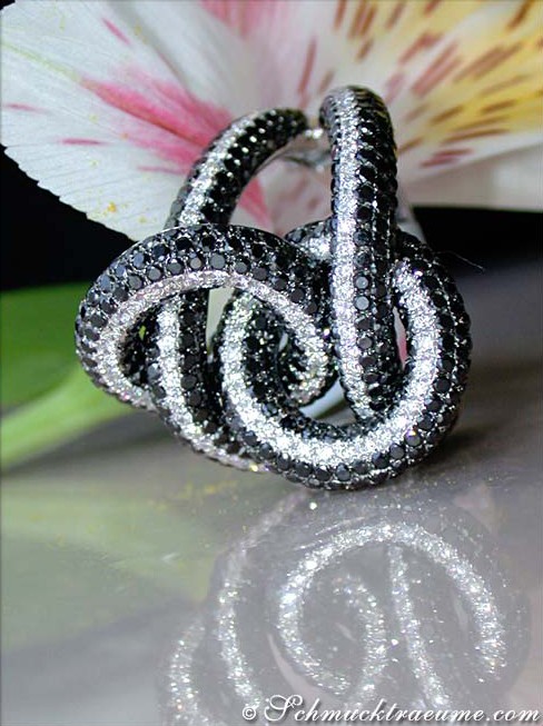 Schwarz-weißer Diamant-Ring mit Verzierung, Detailaufnahme, glänzende Schleifenform, elegant.