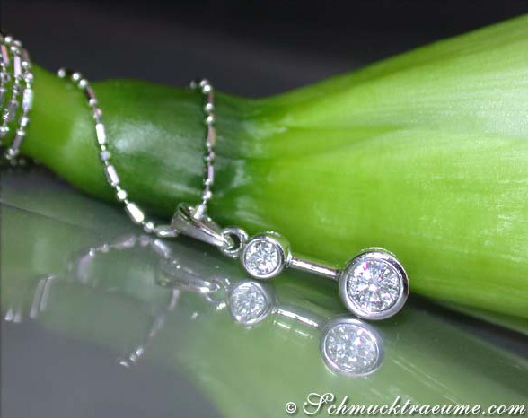 Diamant-Solitär-Halskette aus Weißgold, zarte Kettenperspektive mit grünem Hintergrund.