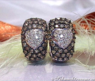 Weißgold Herz Ohrstecker mit braunen und weißen Brillanten, detailreich, elegant, auf Federn präsentiert.