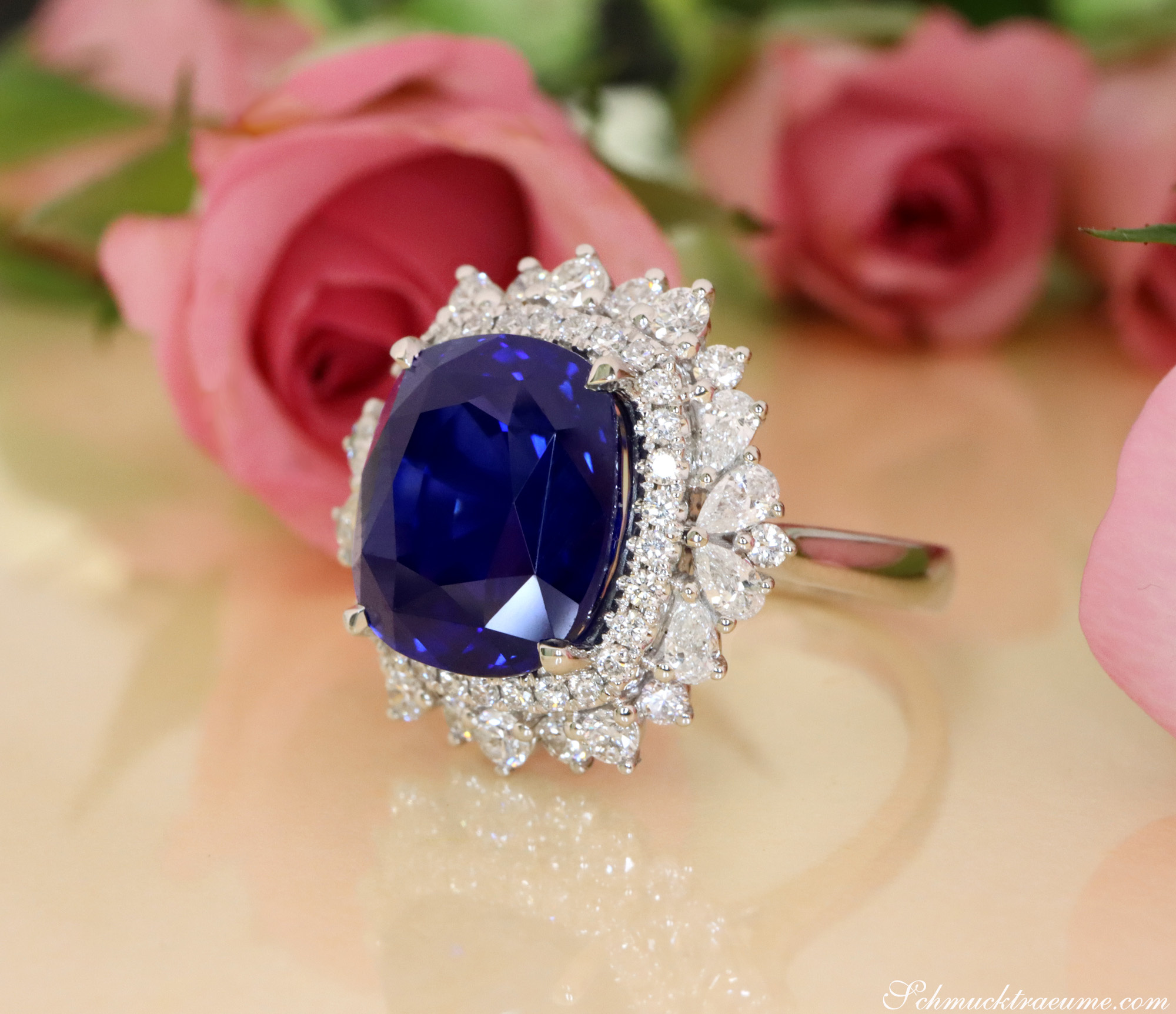 Blauer Ceylon-Saphir-Ring mit Diamant-Kranz auf Rosenhintergrund