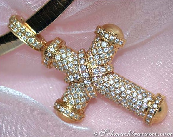 Gelbgold 750 Kreuzanhänger mit Brillanten, detailreich, auf rosa Stoff liegend