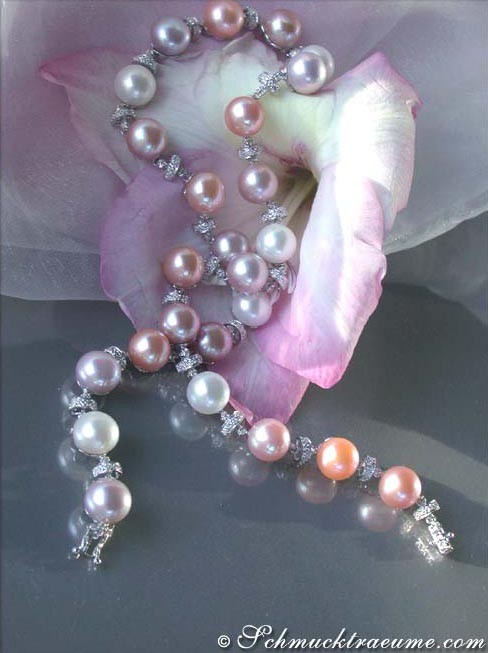 Multicolor Süßwasserperlen-Collier mit makellosem Glanz, zarte Farbnuancen, elegant auf rosa Blüte präsentiert