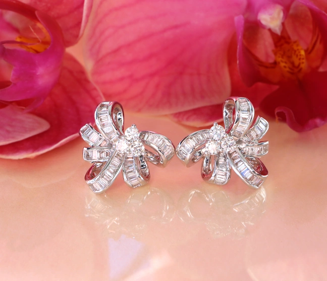 Diamantenschleifen-Ohrringe in Weißgold, detailreich, vor Orchidee, elegant. Diamantenschleifen-Ohrringe in Weißgold, detailreich, vor Orchidee, elegant.