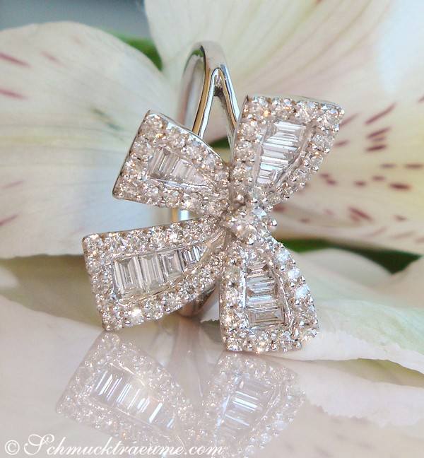 Detail des Diamanten-Schleifen-Rings in Weißgold, elegant auf Blüte präsentiert