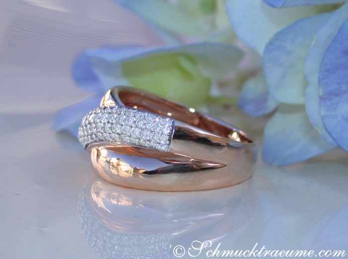 Roségold-Ring mit Diamanten, überkreuzt, auf Blütenblatt liegend