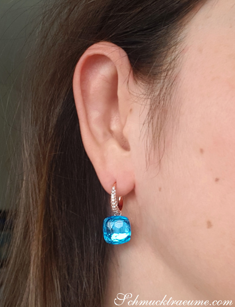 Blautopas-Ohrring mit Diamanten, Detailaufnahme, roségoldener Haken, klares Blau, elegant.