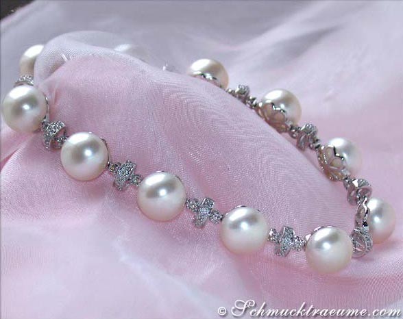 Weißgold 585 Süßwasserperlen-Armband mit Diamanten, Detailaufnahme auf rosa Stoff.
