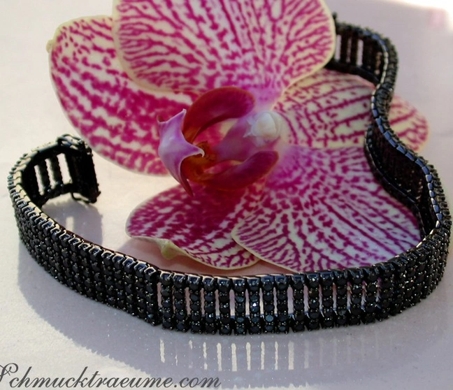 Schwarz rhodiniertes Weissgold-Armband mit 410 Diamanten, Detailaufnahme auf Orchidee. Schwarz rhodiniertes Weissgold-Armband mit 410 Diamanten, Detailaufnahme auf Orchidee.