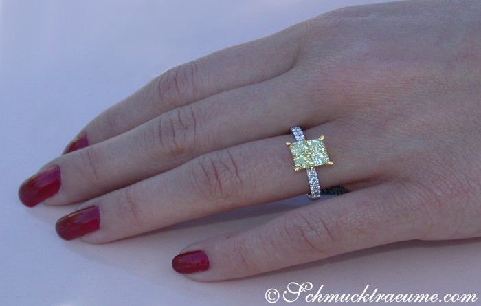 Detailansicht: Gelber Diamantenring im Carré-Design auf Hand mit roten Nägeln