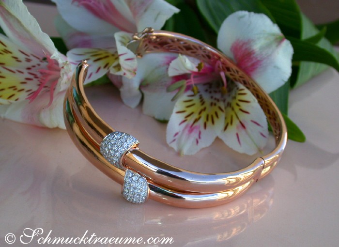 Roségold-Armreif mit Brillanten, Detailaufnahme, Blumen im Hintergrund