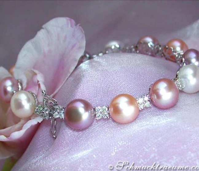 Süßwasserperlen-Armband mit Diamanten, Detailaufnahme auf rosa Stoff, Blütenblatt im Hintergrund. Süßwasserperlen-Armband mit Diamanten, Detailaufnahme auf rosa Stoff, Blütenblatt im Hintergrund.