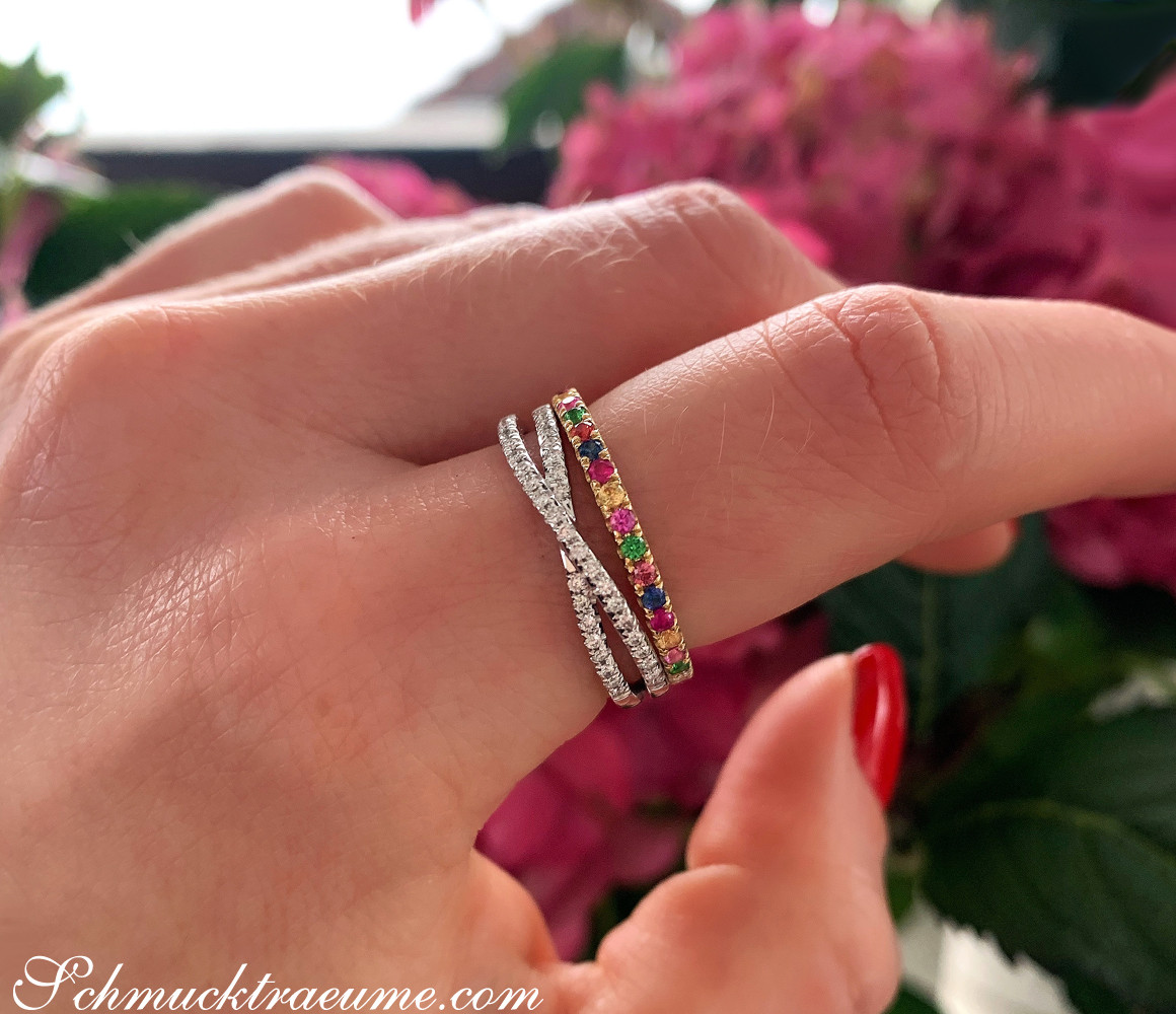 Zarte Diamantringe in Weißgold, Detailaufnahme auf blühendem Hintergrund