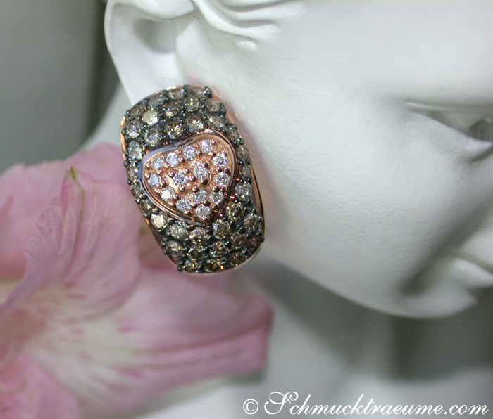 Herzform-Ohrstecker mit braunen und weißen Brillanten, getragen auf Mannequin, Detailaufnahme