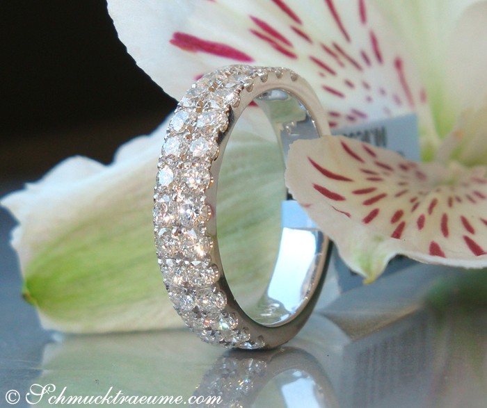 Detailansicht des edlen Brillanten Memory Rings in Weißgold 750, zweireihig, auf glänzender Oberfläche, umgeben von