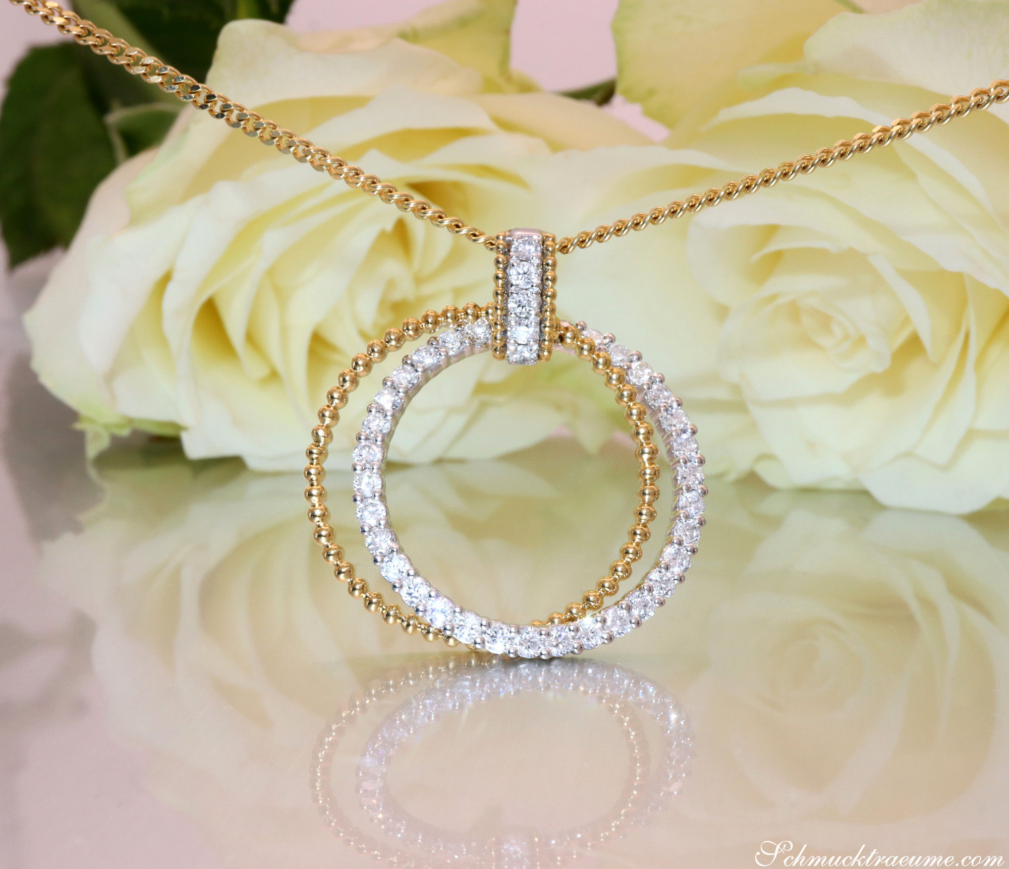 Goldener Kreisanhänger mit Brillanten auf Rosenhintergrund