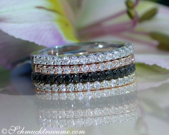 Drei elegante Diamantringe in Weiß-, Gelb- & Roségold, 0.780 Karat, W SI, auf glänzender Oberfläche.