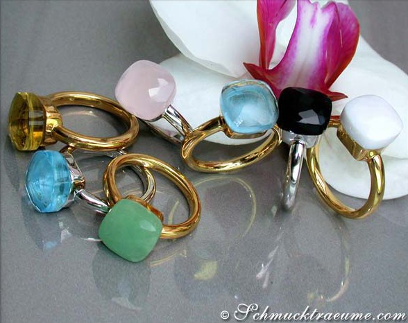 Farbenprächtige Zitronenquarzringe mit Gelbgold 750, präsentiert auf Blütenblättern