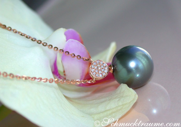 Detailansicht: Edler Tahitiperlen-Anhänger mit Diamanten in Roségold, auf Orchideenblüte gelegt