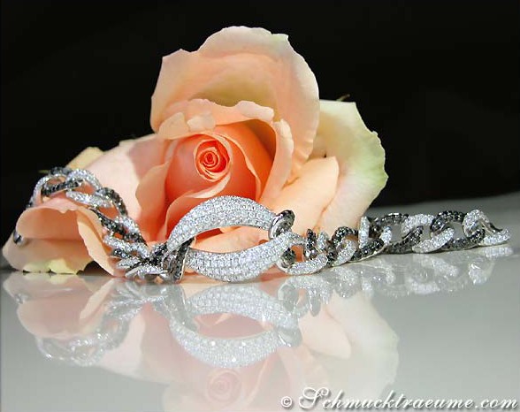 Detailliertes Armband mit schwarzen und weißen Diamanten auf Rosenblüte.