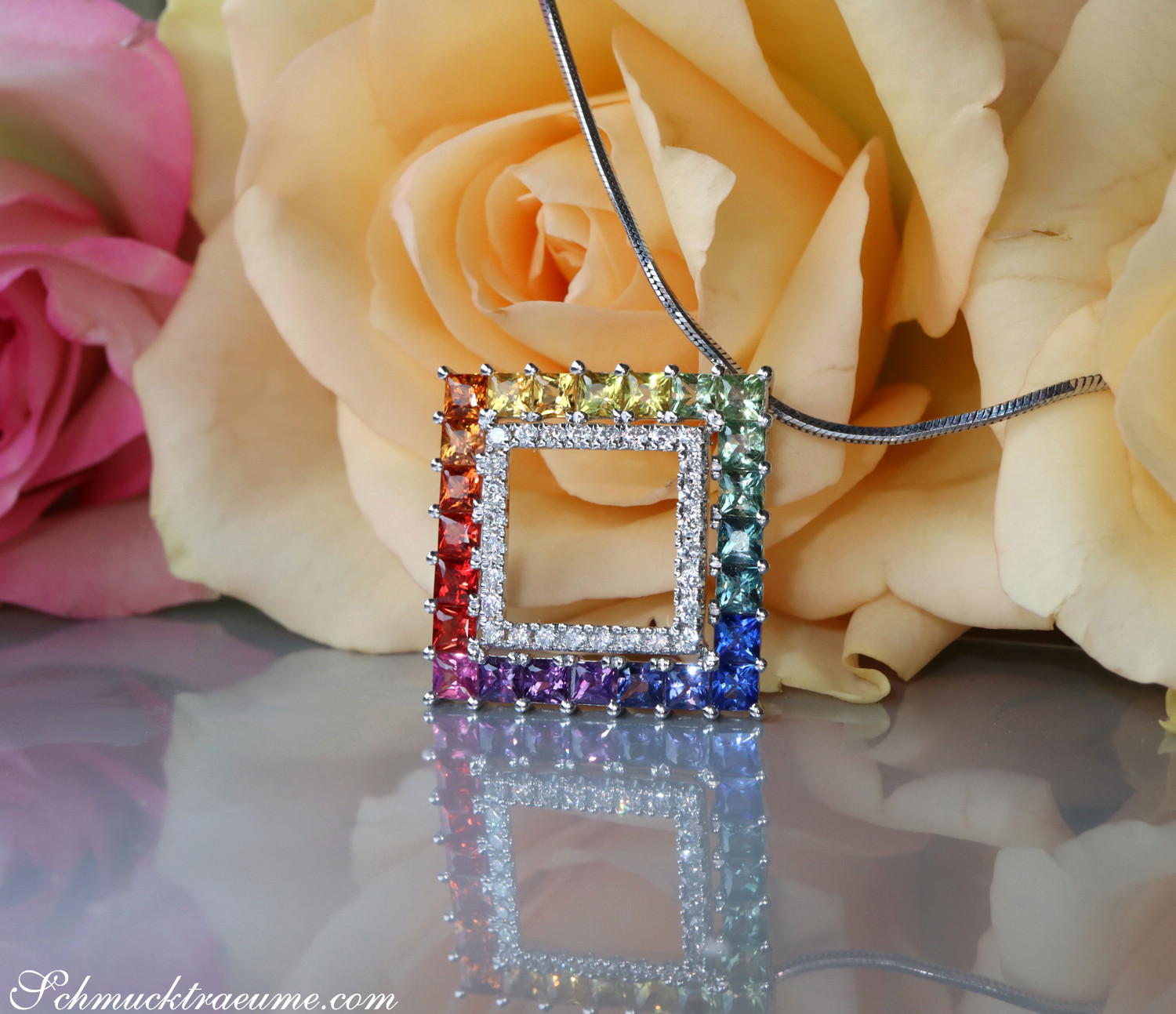 Blumiger Hintergrund mit Rosen, farbenfroher Saphir-Anhänger mit Brillanten, Detailaufnahme