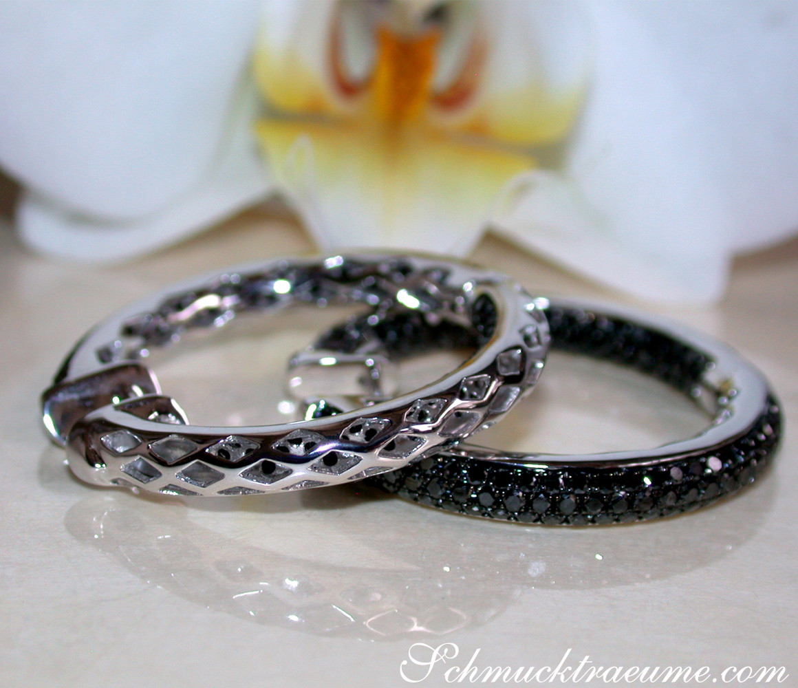 Schwarze Diamant-Creolen aus Weißgold, detailreich gestaltet, auf weißem Hintergrund.