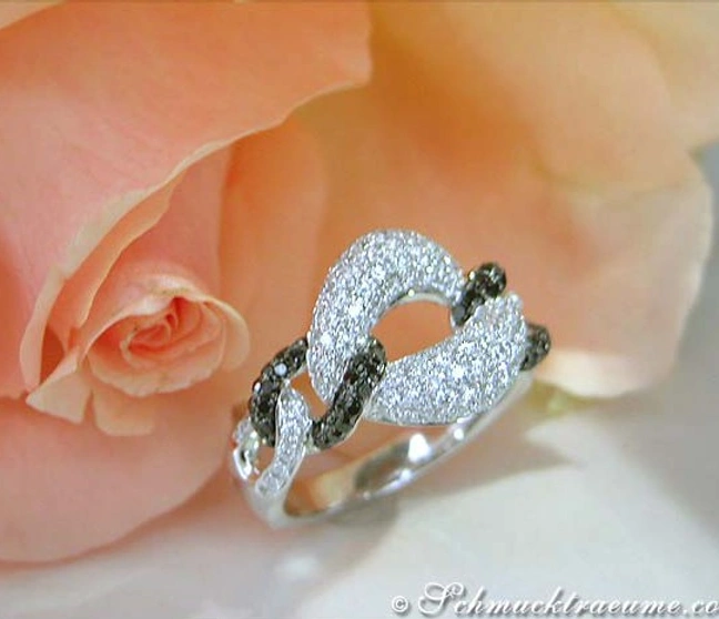 Diamantring mit schwarzen und weißen Diamanten, Gliederdesign, auf rosa Rose platziert Diamantring mit schwarzen und weißen Diamanten, Gliederdesign, auf rosa Rose platziert