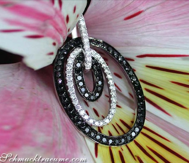 Schwarz-weißer Diamant-Anhänger im Oval, Detailaufnahme, auf Blume getragen Schwarz-weißer Diamant-Anhänger im Oval, Detailaufnahme, auf Blume getragen