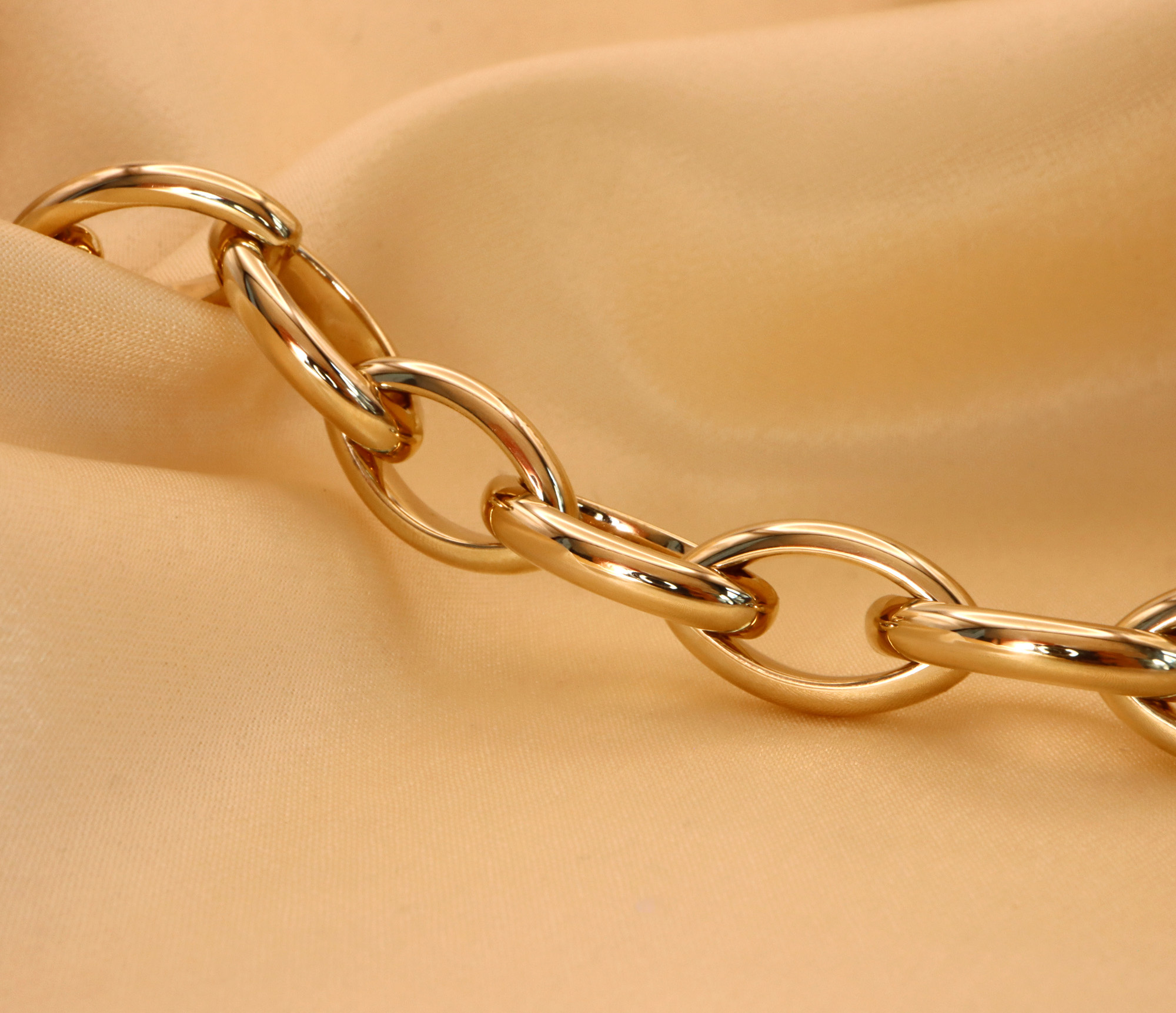 Goldene Navette-Armbandkette aus Gelbgold 585/000, Detailaufnahme auf Samt, glänzende Verbindungselemente.