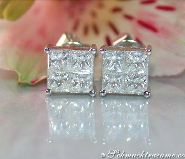 Princess-Diamanten-Ohrstecker in Weißgold, elegant auf Marmorplatte mit Blume im Hintergrund Princess-Diamanten-Ohrstecker in Weißgold, elegant auf Marmorplatte mit Blume im Hintergrund