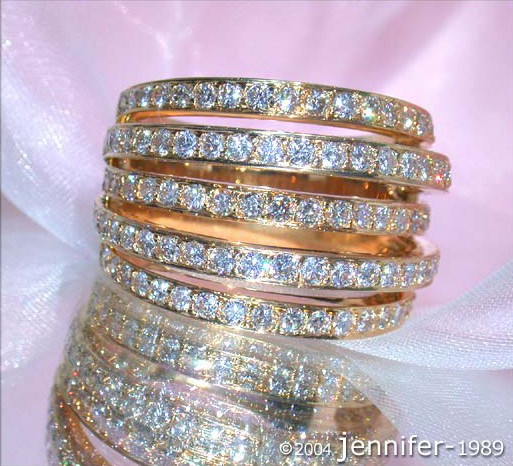 Gelbgold 750 Mehrreihiger Brillantenring, Detailaufnahme, elegant, funkelnd, auf rosa Tuch.
