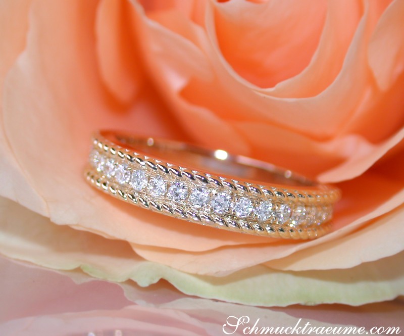 Kordel-Diamantring auf Rosenblüte, elegante Verbindung aus Gold und Diamanten