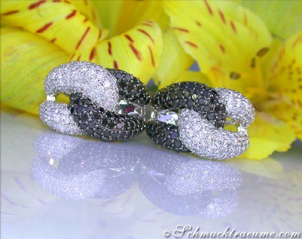 Detailansicht der üppigen Brillanten & schwarzen Diamanten Ohrstecker auf glänzender Oberfläche