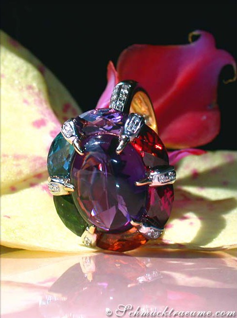 Multicolor-Edelstein-Ring mit Amethyst und Citrin, getragen auf rosafarbenem Hintergrund