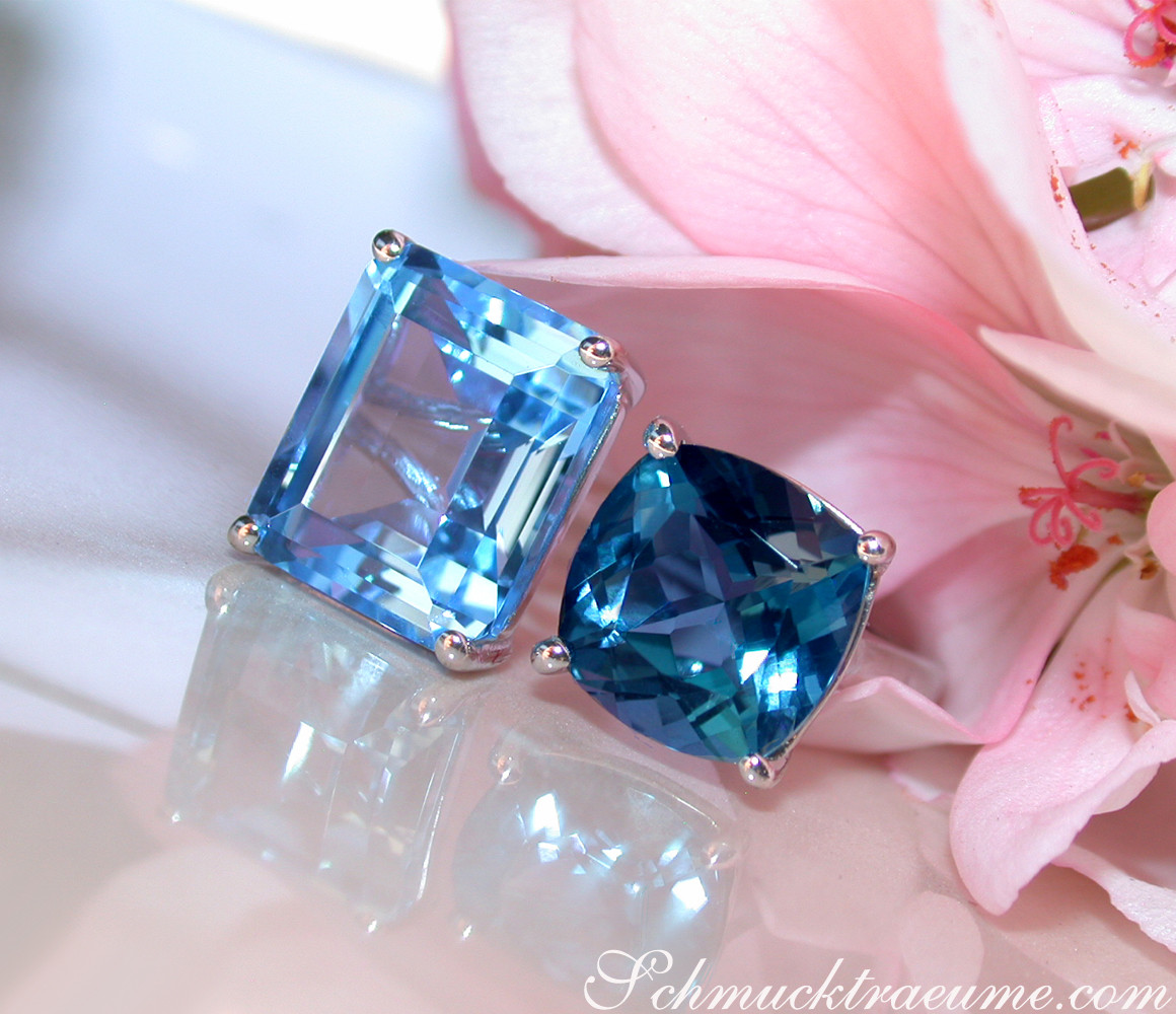 Blautopas-Ringe in Weißgold 585, Detailaufnahme, klare Formen, elegant, Blüten im Hintergrund